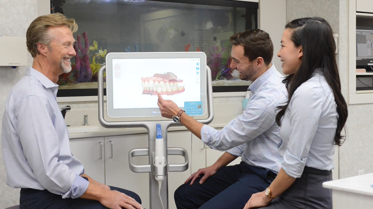 Dr. Kevin with Dr. Philip and Dr. Kat looking at an orthodontic scan