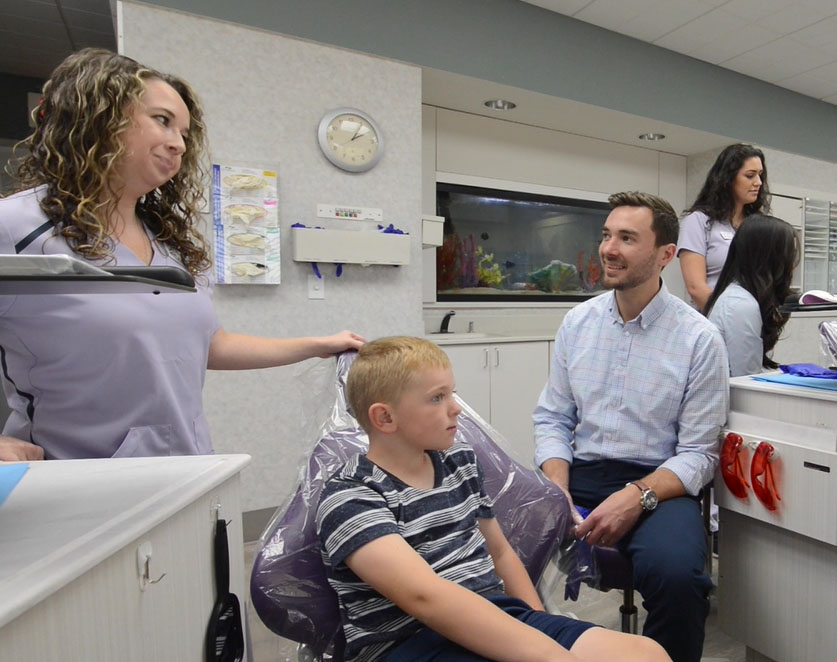Dr. Philip and Assistant Alana with a patient in the chair